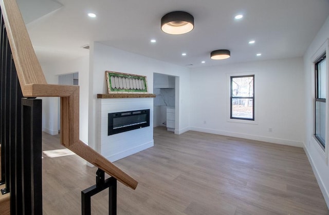 unfurnished living room featuring light hardwood / wood-style floors