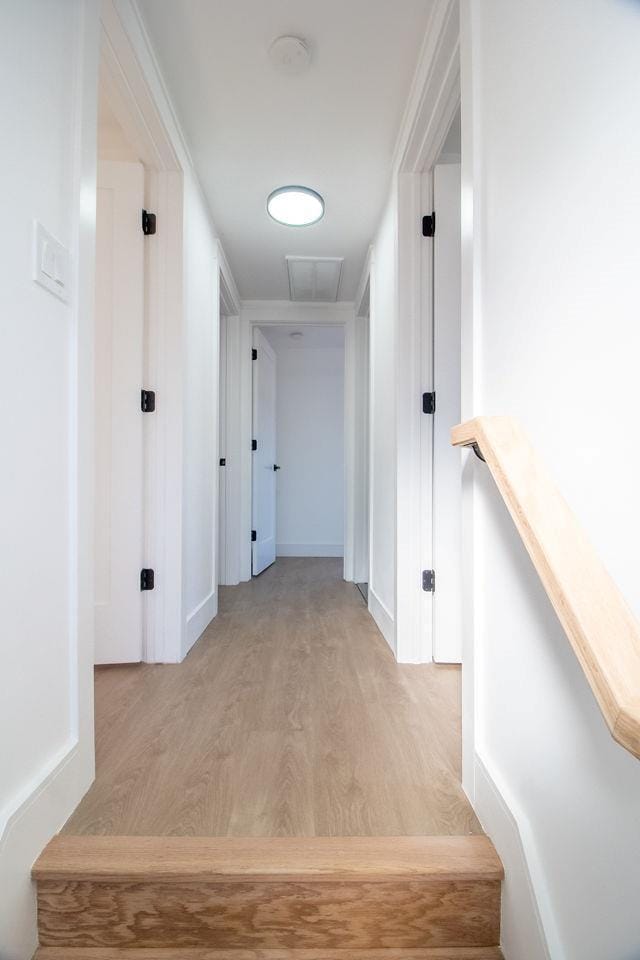 hallway with wood-type flooring