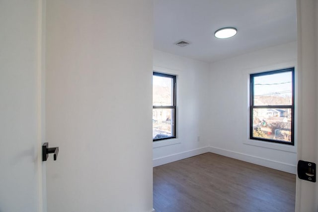 spare room featuring dark hardwood / wood-style flooring