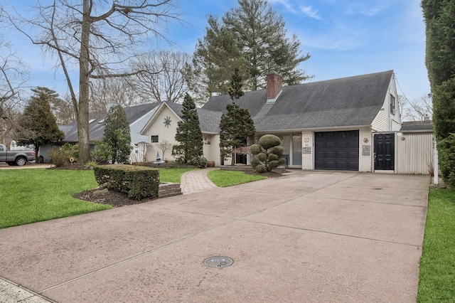 view of front of house with a garage and a front yard