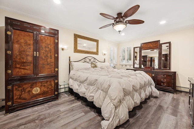 bedroom featuring baseboard heating, ornamental molding, wood-type flooring, and ceiling fan