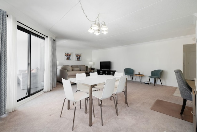 carpeted dining space with a notable chandelier