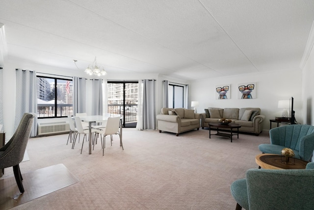 living room featuring a chandelier, light carpet, and a textured ceiling