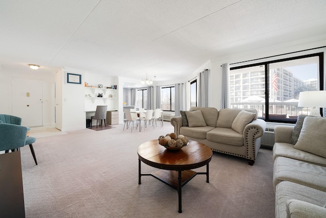 carpeted living room featuring a textured ceiling and a notable chandelier