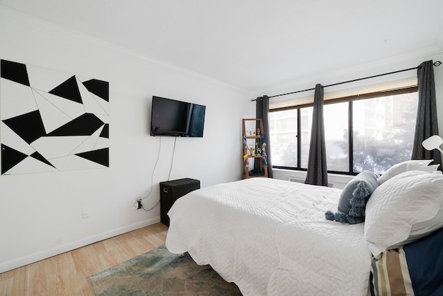 bedroom with crown molding and hardwood / wood-style flooring