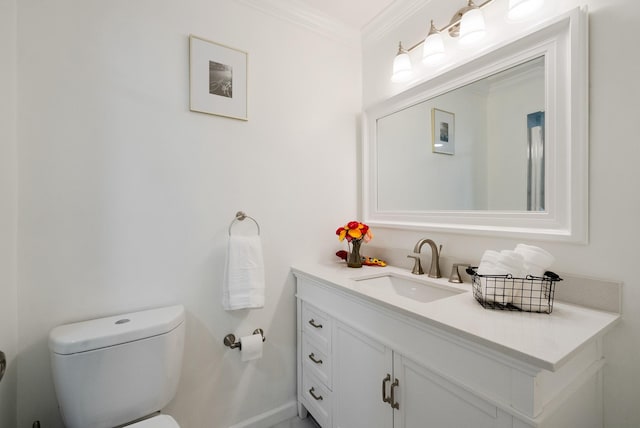 bathroom featuring vanity, crown molding, and toilet