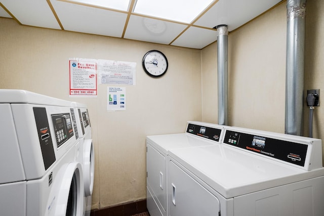 clothes washing area with separate washer and dryer