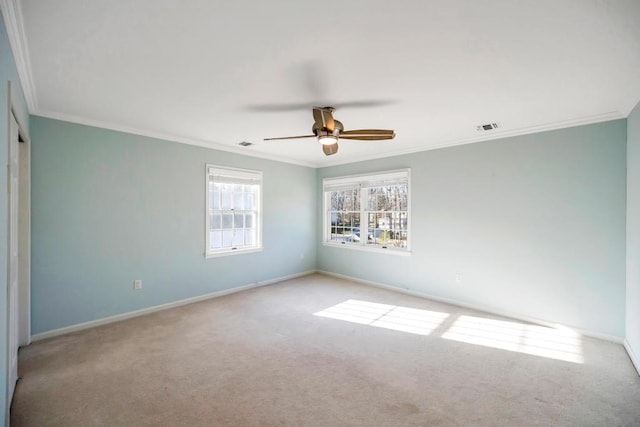 spare room with visible vents, crown molding, baseboards, and carpet floors