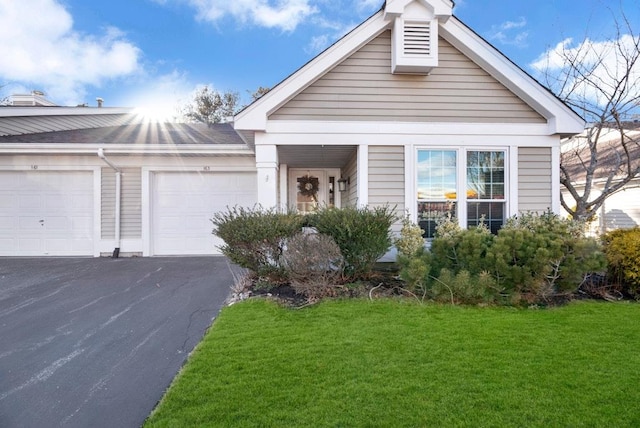 view of front of home with a garage and a front yard