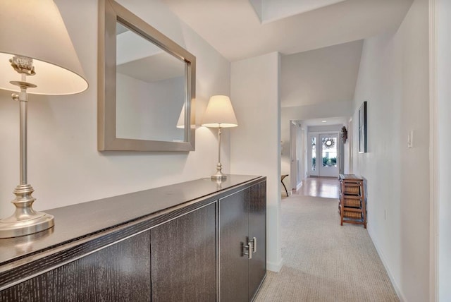 hallway featuring light colored carpet