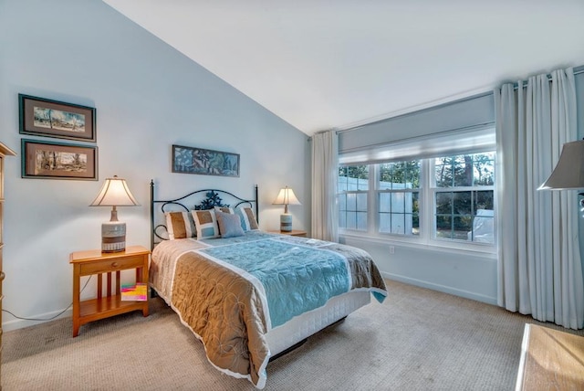 bedroom featuring lofted ceiling and carpet