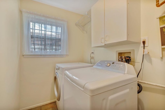 washroom with washing machine and dryer and cabinets