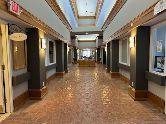 hall featuring ornamental molding and ornate columns