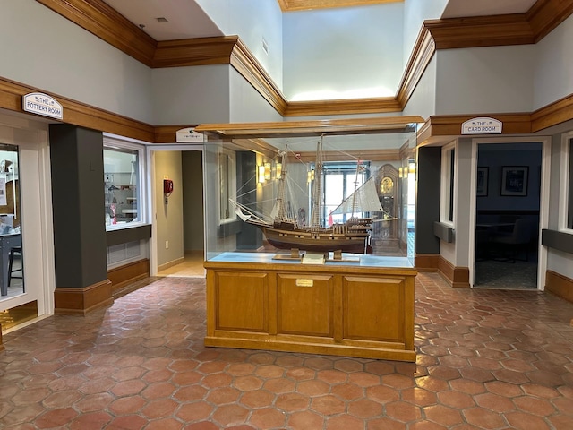 kitchen featuring a towering ceiling and ornamental molding