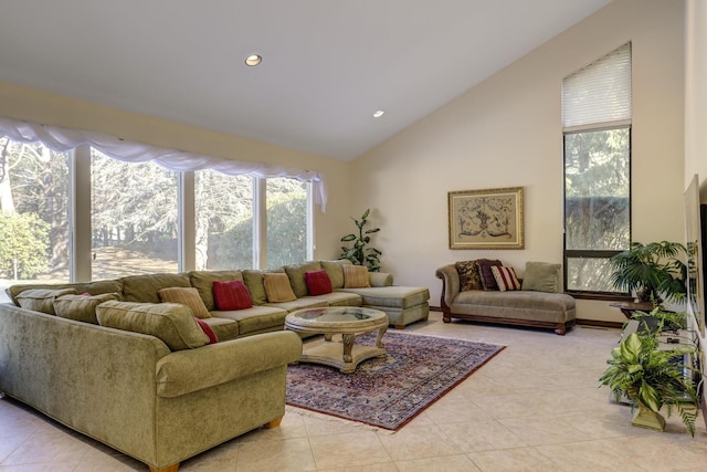 living room with light tile patterned flooring and high vaulted ceiling