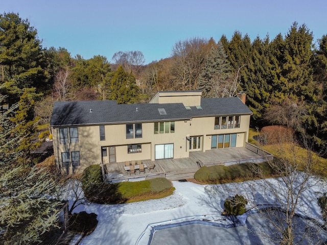 rear view of property with a wooden deck and a patio area