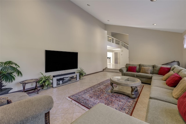 living room featuring light tile patterned floors and high vaulted ceiling