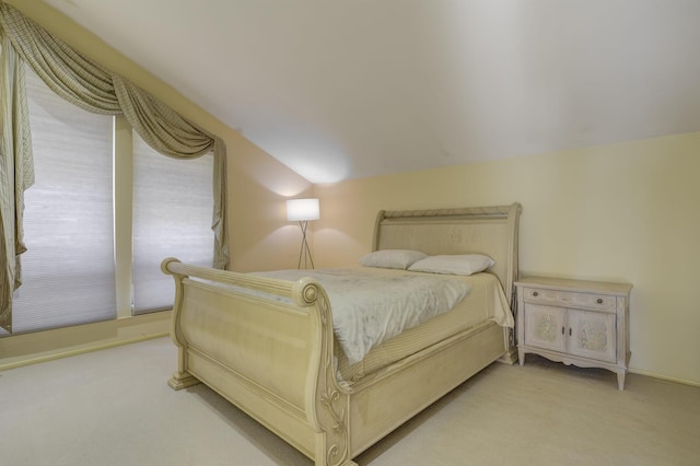 bedroom featuring lofted ceiling, access to outside, and light colored carpet