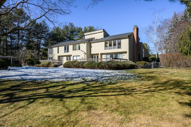 view of front of property with a chimney and a front lawn