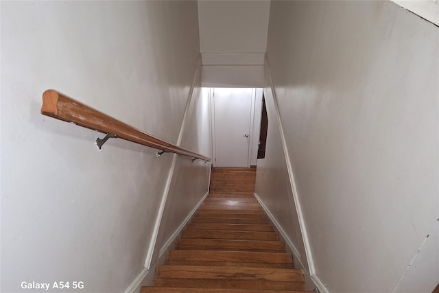 staircase with hardwood / wood-style floors