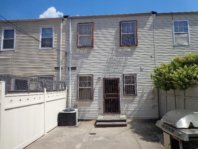 rear view of house with central AC and a patio area