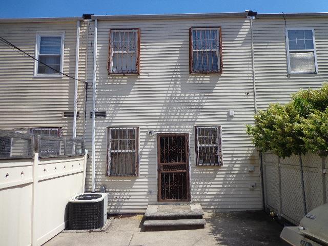 rear view of house featuring central AC