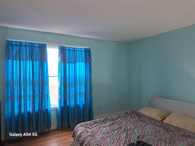 bedroom with hardwood / wood-style flooring