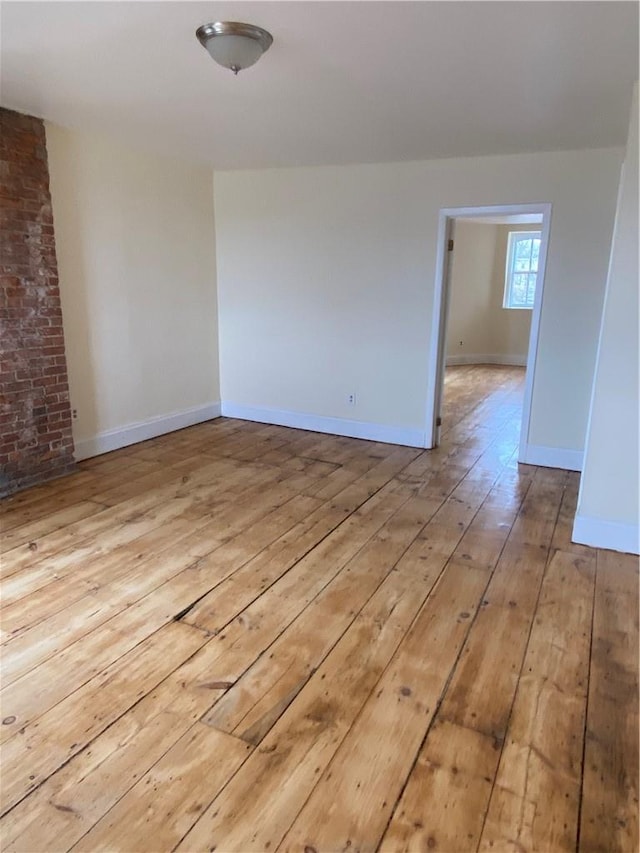 empty room with light hardwood / wood-style flooring