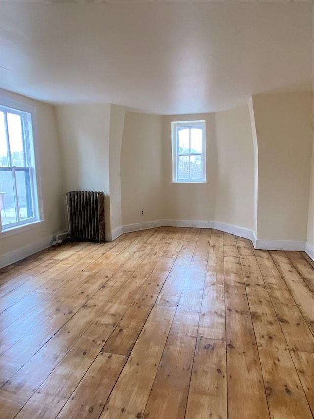 spare room with radiator and light hardwood / wood-style flooring