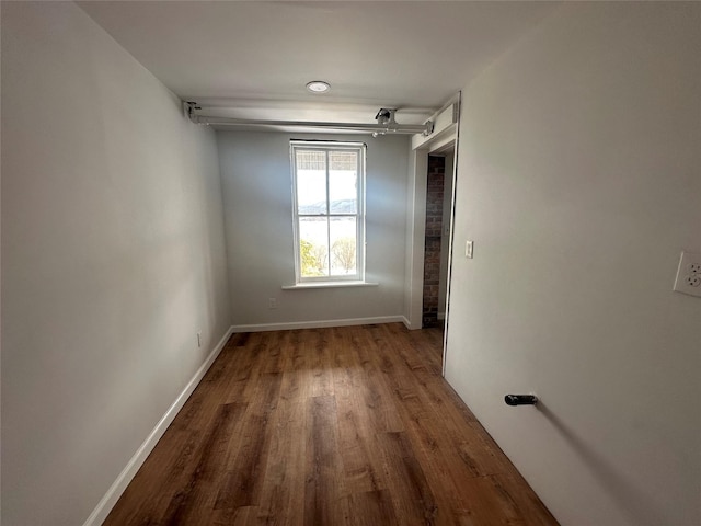 empty room with wood-type flooring