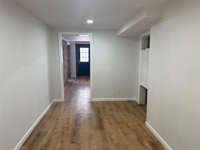 hallway with dark wood-type flooring