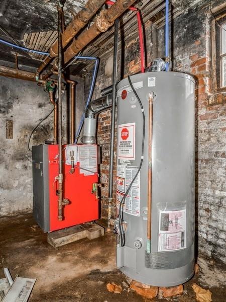 utility room featuring water heater