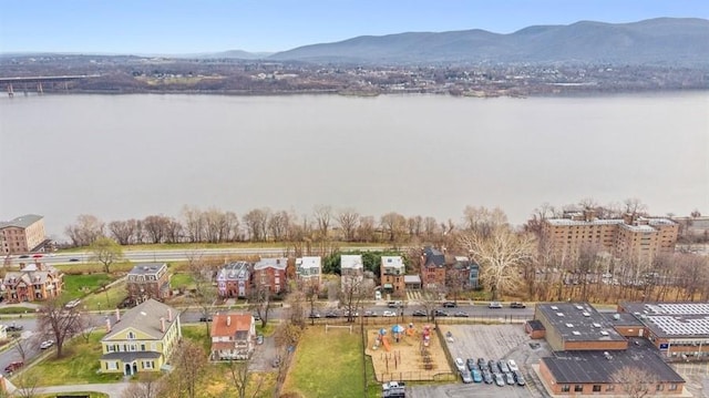 drone / aerial view featuring a water and mountain view