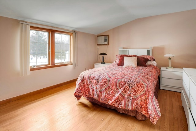 bedroom featuring vaulted ceiling and light hardwood / wood-style flooring