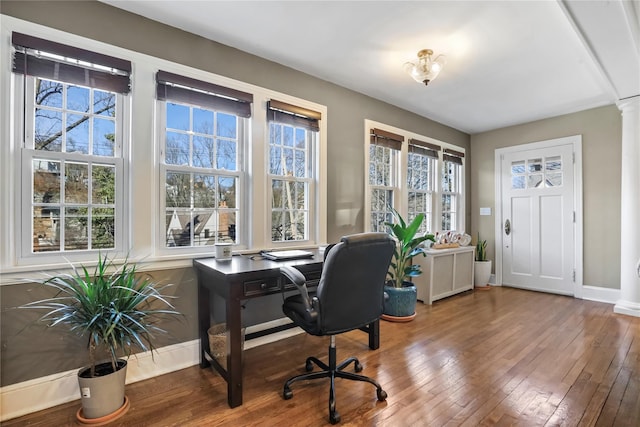 office space with hardwood / wood-style flooring and decorative columns