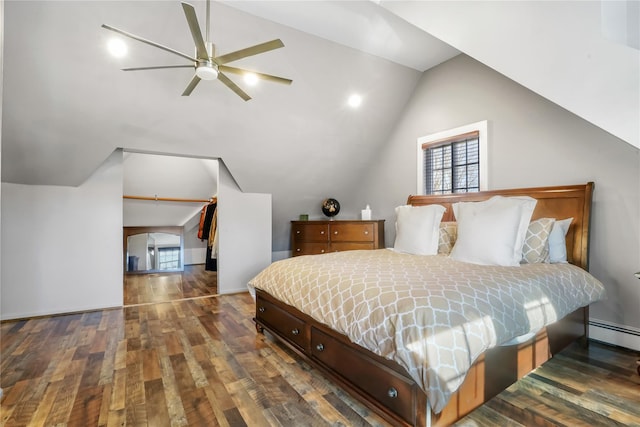 bedroom with baseboard heating, dark hardwood / wood-style floors, and vaulted ceiling