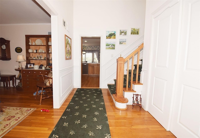 entrance foyer featuring hardwood / wood-style floors and ornamental molding