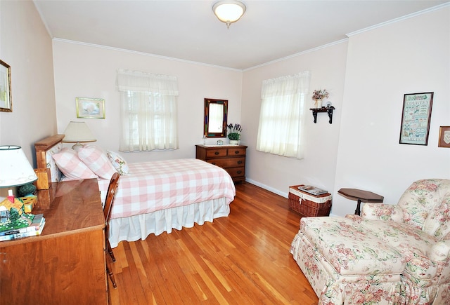 bedroom featuring hardwood / wood-style flooring and crown molding