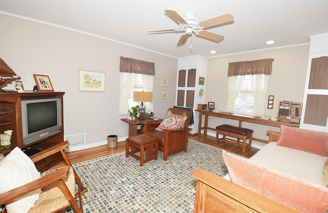 living room with crown molding, ceiling fan, and hardwood / wood-style flooring