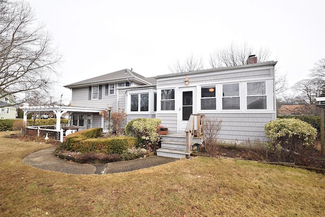 view of front of home featuring a front lawn and a pergola