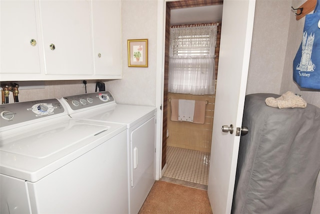 laundry room with cabinets and washer and clothes dryer