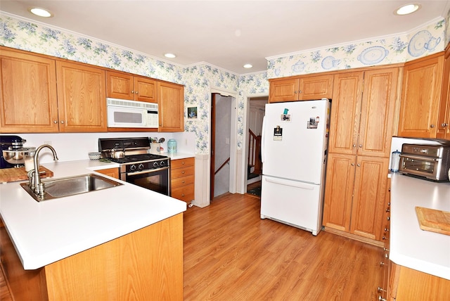 kitchen featuring sink, white appliances, kitchen peninsula, and light wood-type flooring