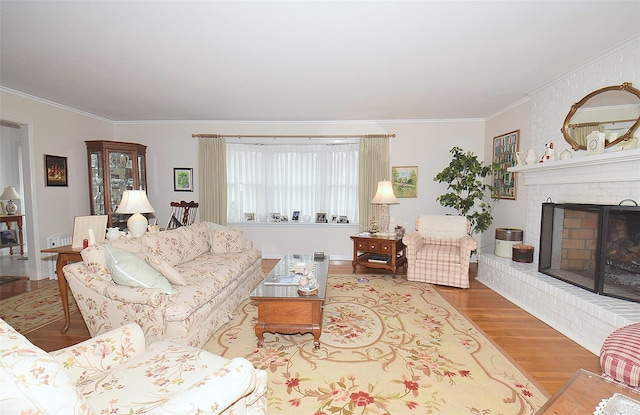 living room with hardwood / wood-style floors, a fireplace, and ornamental molding