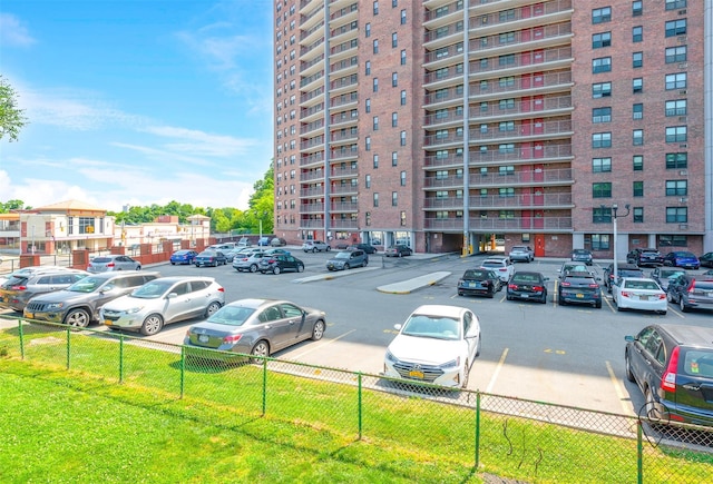 view of vehicle parking with a lawn