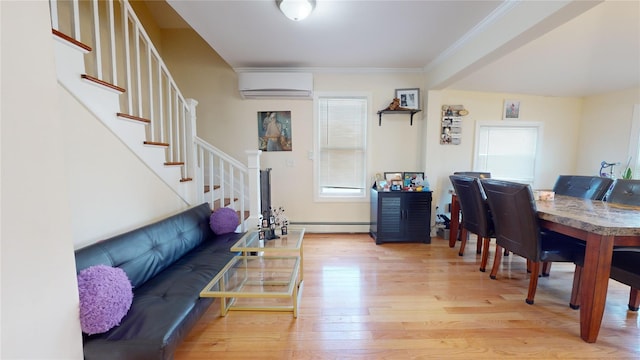 dining room with a wealth of natural light, a wall unit AC, a baseboard radiator, and light wood-type flooring