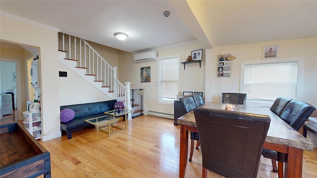 dining area featuring a baseboard radiator, crown molding, hardwood / wood-style floors, and a wall unit AC