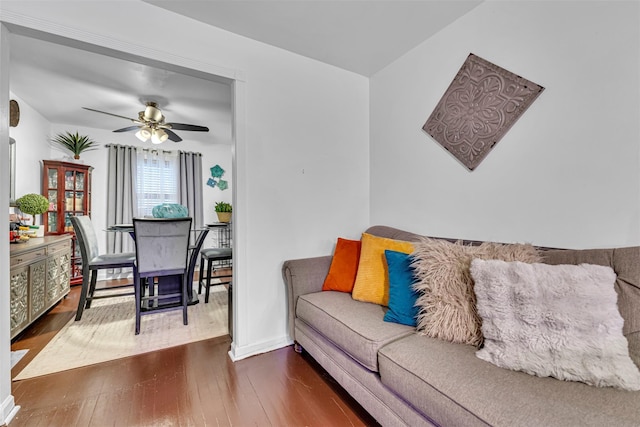 living room with ceiling fan and dark hardwood / wood-style floors