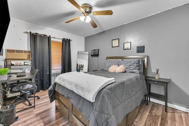 bedroom with hardwood / wood-style flooring and ceiling fan