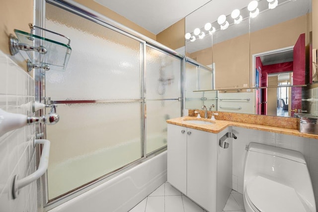 full bathroom with shower / bath combination with glass door, vanity, toilet, and tile patterned flooring