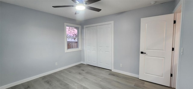 unfurnished bedroom with ceiling fan, light hardwood / wood-style floors, and a closet